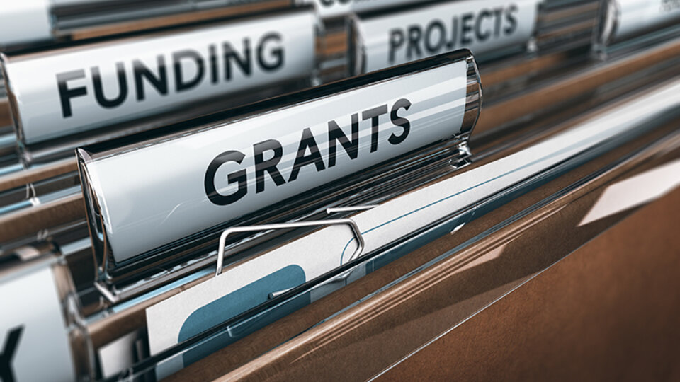 file folders that are labeled funding and grants