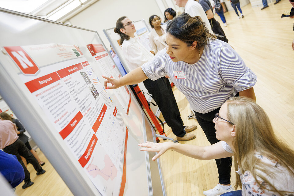 two students looking at posters